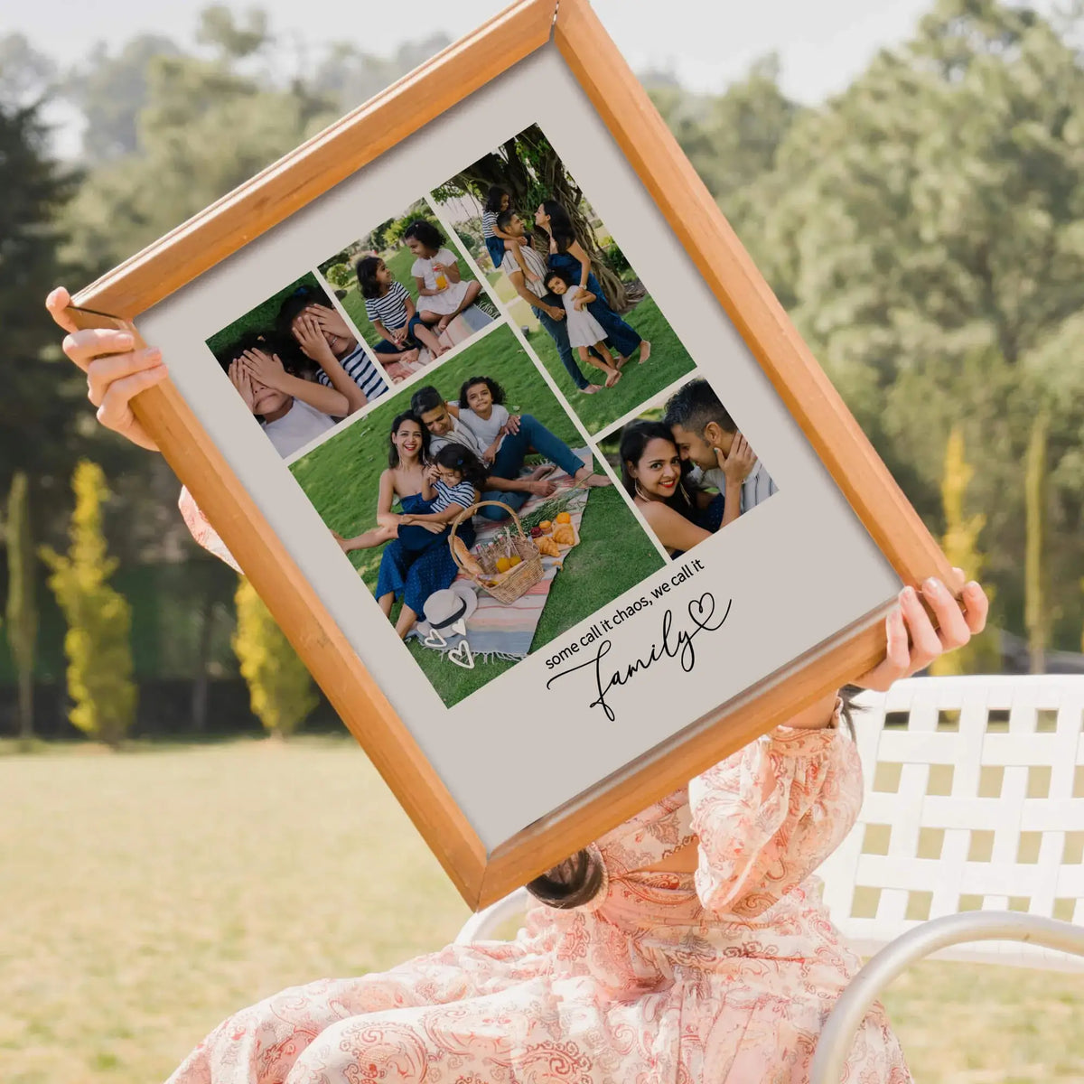 Woman holding framed family photo collage sitting outside