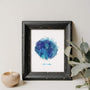 framed blue watercolour portrait next to candle