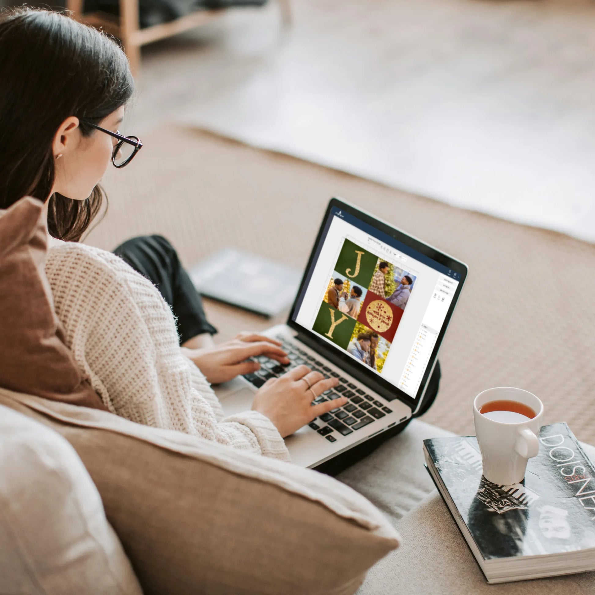 woman editing photo collage from laptop next to cup of tea