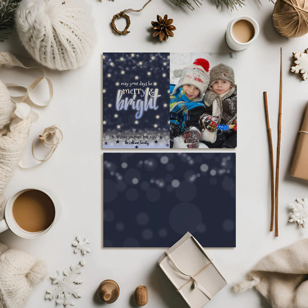 Navy holiday photo card front and back design on flat lay with winter props