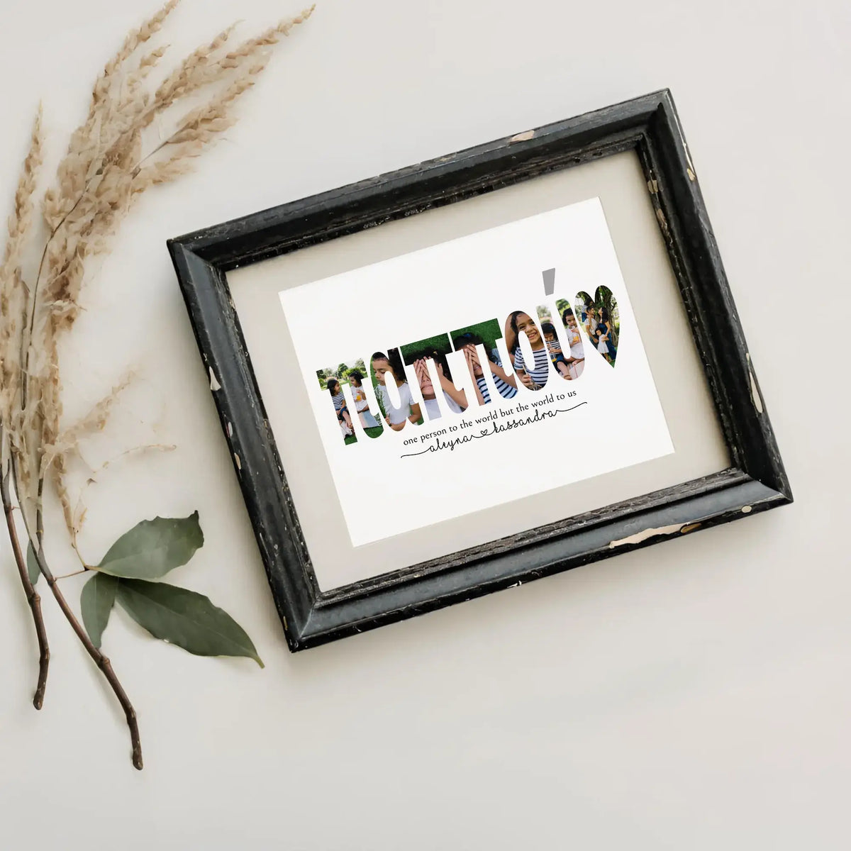 Pappou photo collage in distressed black frame next to dried pampas grass.