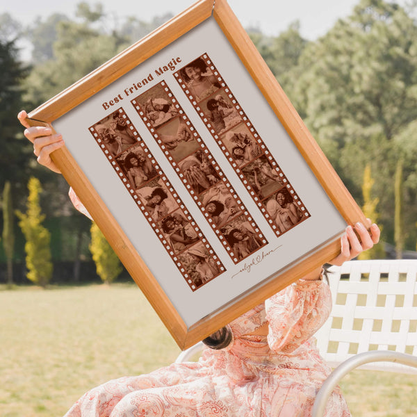 Seated woman holding framed best friend collage in outdoor setting