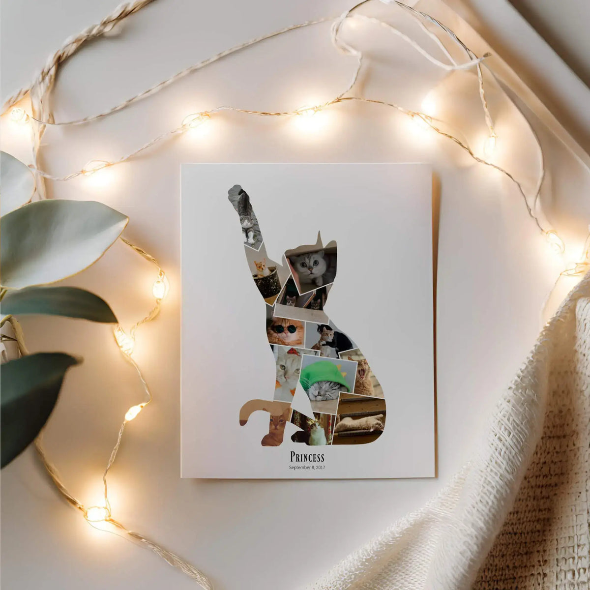 Cat Silhouette Photo Collage print laying next to cream coloured linen surrounded by string lights