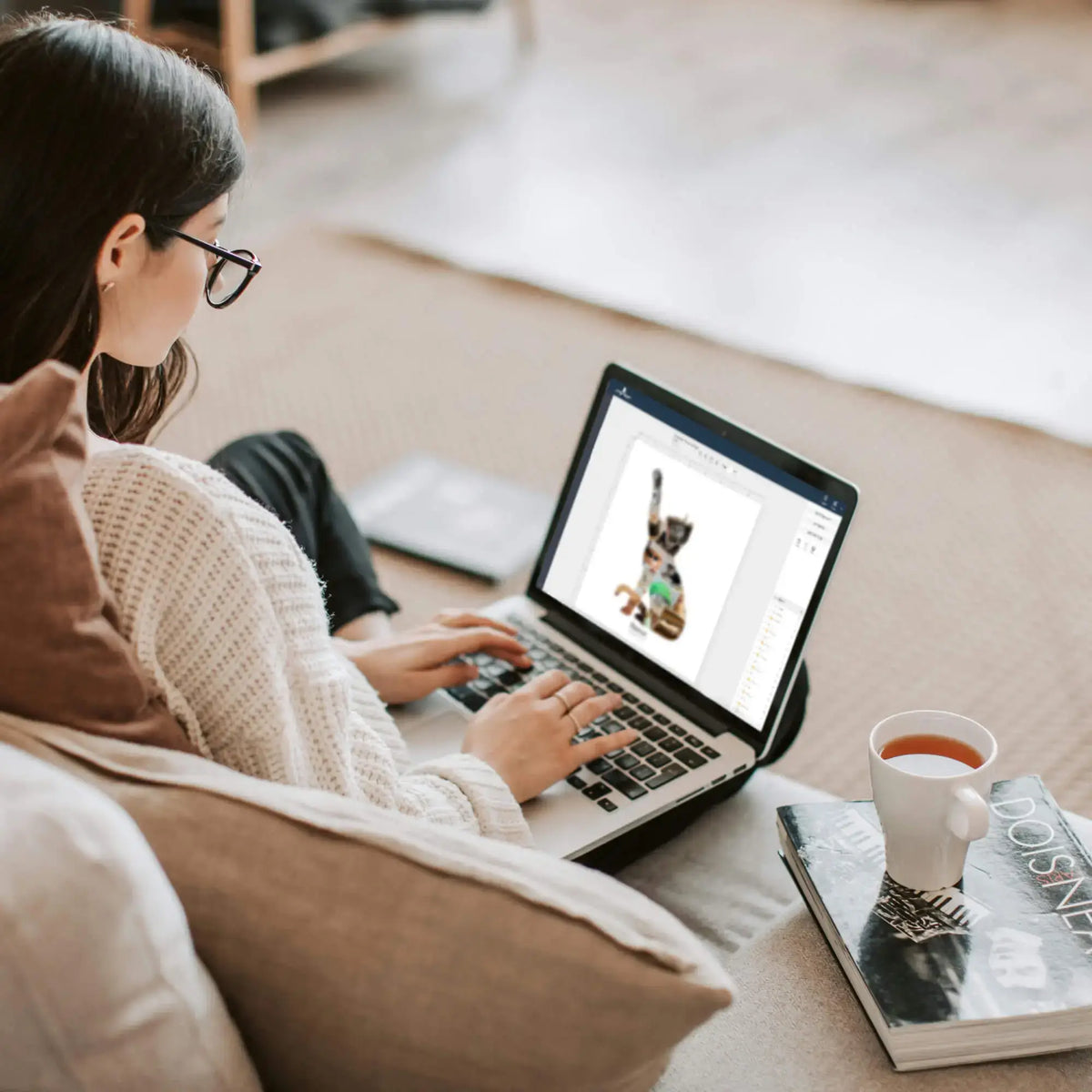 Woman editing Cat Silhouette Photo Collage template from laptop with a cup of tea next to her