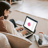 Woman editing pink watercolour portrait template on laptop