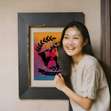 Woman next to framed colourful portrait