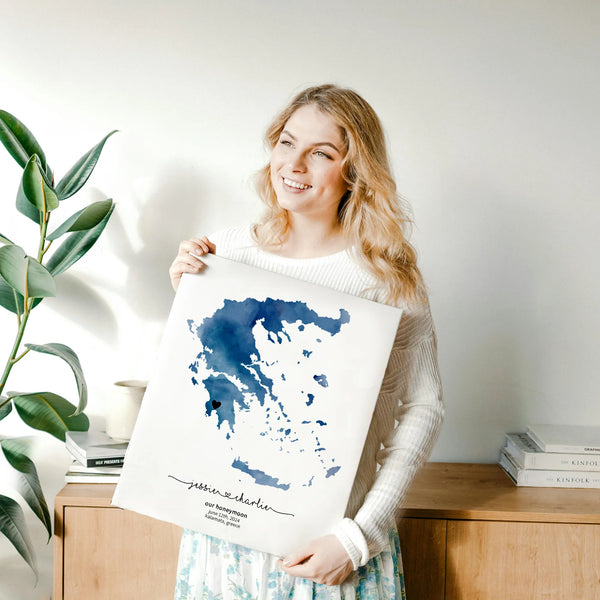 Woman holding blue watercolour greek map