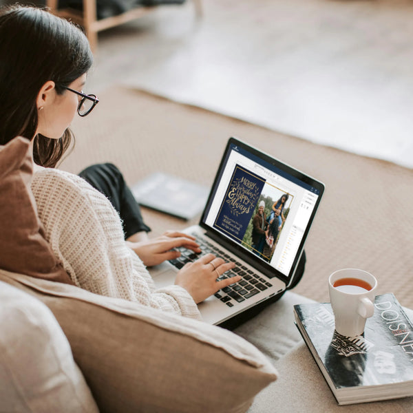 Woman editing template from laptop with a cup of tea