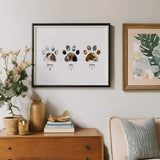 Pet Paw Collage in sleek black frame above vintage bureau with vases and bookas