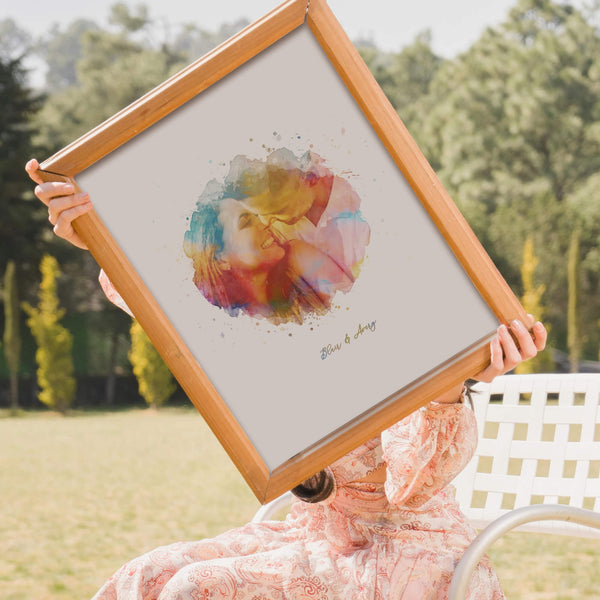 Woman holding framed rainbow watercolour portrait