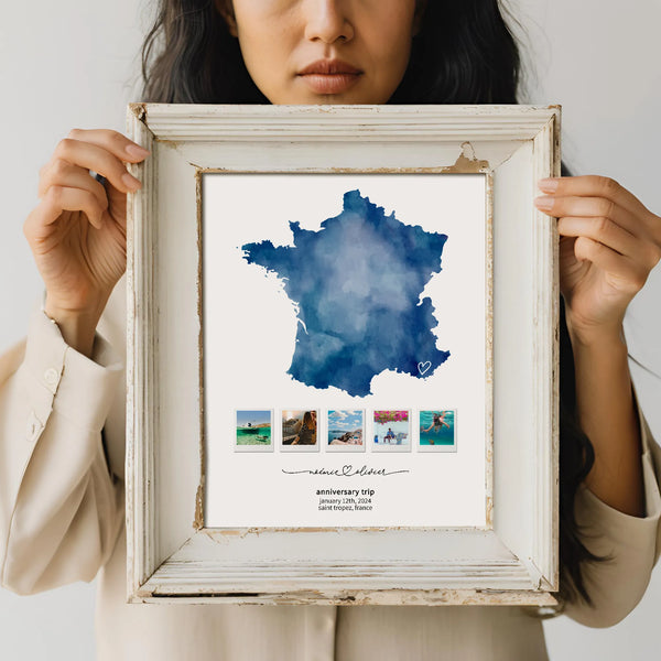 Woman holding distressed white frame with a print of Blue Map of France