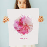 Little girl holding print of pink watercolour portrait