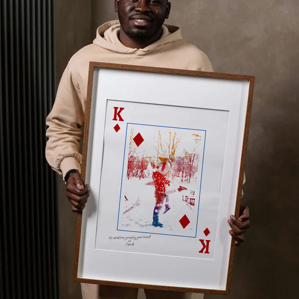 Man holding King of Diamonds Style Portrait in large, thin, wooden frame.