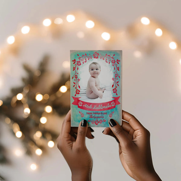 Feminine hand holding card with string lights in the background