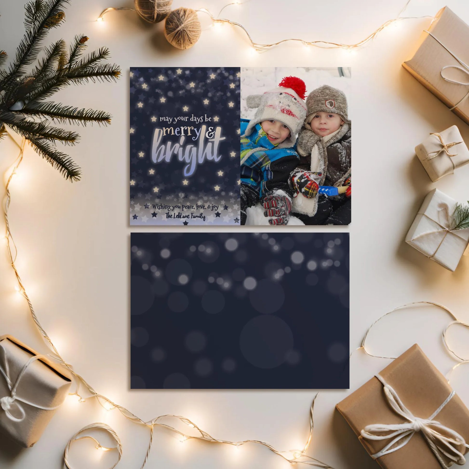 Navy holiday photo card front and back design on flat lay with winter props