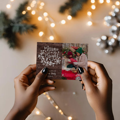 Woman Holding Christmas Photo Card with String lights in background