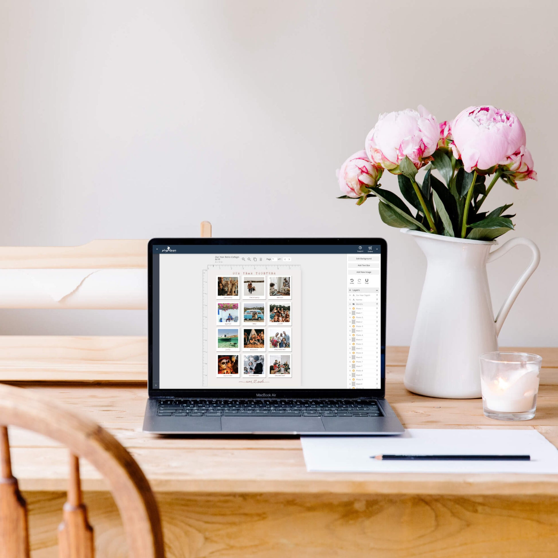 Laptop open to photo collage template on table next to vase with flowers