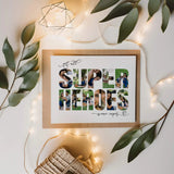 Super Heroes Photo Collage print lying next to cream leaves and surrounded by string lights.